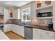 Well-lit kitchen features stone backsplash, stainless steel appliances, and ample cabinet space at 3278 Shakerley Park, Douglasville, GA 30135