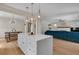 Open-concept kitchen features a large island, pendant lighting, and seamless flow into the living spaces at 3278 Shakerley Park, Douglasville, GA 30135