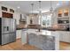 Modern kitchen features a center island with stone accents, pendant lights, and stainless steel appliances at 3278 Shakerley Park, Douglasville, GA 30135