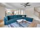 Bright living space with large blue sectional sofa, hardwood floors, and seamless flow to the kitchen at 3278 Shakerley Park, Douglasville, GA 30135