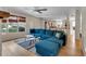 Open concept living room with blue sectional sofa, shiplap walls, and hardwood floors overlooking the kitchen at 3278 Shakerley Park, Douglasville, GA 30135