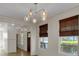 Bright open-concept living room with modern lighting, shiplap, and hardwood floors and woven window shades at 3278 Shakerley Park, Douglasville, GA 30135