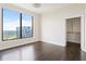Bedroom with hardwood floors, large window with city views, and access to a walk-in closet at 3445 Stratford Ne Rd # 3403, Atlanta, GA 30326