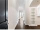 Bright hallway boasts hardwood floors and built-in shelving, leading to an airy living space at 3445 Stratford Ne Rd # 3403, Atlanta, GA 30326