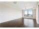 Bright living room features beautiful hardwood floors and large windows with a city view at 3445 Stratford Ne Rd # 3403, Atlanta, GA 30326