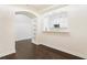 Open living space with hardwood floors, archway, and view of the kitchen at 3445 Stratford Ne Rd # 3403, Atlanta, GA 30326