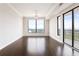 Sun-filled living room with hardwood floors and scenic city views from large windows at 3445 Stratford Ne Rd # 3403, Atlanta, GA 30326