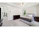 Spacious bedroom features neutral colors, tray ceiling, and plush carpet, creating a serene retreat at 350 Eagle Tiff Dr, Sugar Hill, GA 30518