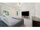 Bright bedroom with tray ceiling, plush carpet, and large windows, creating an inviting and comfortable space at 350 Eagle Tiff Dr, Sugar Hill, GA 30518