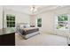 Inviting bedroom with tray ceiling, large windows offering great natural light, and plush carpeting at 350 Eagle Tiff Dr, Sugar Hill, GA 30518