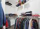 Organized walk-in closet offers ample storage with hanging rods and shelves for efficient organization at 350 Eagle Tiff Dr, Sugar Hill, GA 30518