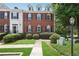 Charming brick townhome with well-manicured lawn and neatly trimmed bushes, providing curb appeal at 350 Eagle Tiff Dr, Sugar Hill, GA 30518