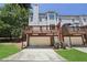 Rear view showing the exterior with a brick foundation and wooden decks above at 350 Eagle Tiff Dr, Sugar Hill, GA 30518