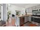 Well-equipped kitchen with granite counters, stainless appliances, and open layout connects to living area at 350 Eagle Tiff Dr, Sugar Hill, GA 30518
