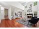 Bright, open living room with hardwood floors, fireplace, and large windows offering lots of natural light at 350 Eagle Tiff Dr, Sugar Hill, GA 30518