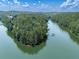 Scenic view of waterfront property with boat docks, perfect for lake living, amidst lush greenery and tranquil waters at 7560 Island Mill Rd, Acworth, GA 30102