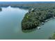 Expansive waterfront property with multiple docks, enveloped by lush greenery and serene waters, offering a private retreat at 7560 Island Mill Rd, Acworth, GA 30102
