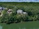 Beautiful home nestled among lush trees on a waterfront property, offering privacy and scenic views of the lake at 7560 Island Mill Rd, Acworth, GA 30102