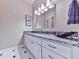 Charming bathroom vanity with a granite countertop, modern lighting, and stylish patterned tile at 7560 Island Mill Rd, Acworth, GA 30102