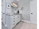 Bathroom featuring a granite countertop vanity with a large framed mirror and white cabinets at 7560 Island Mill Rd, Acworth, GA 30102