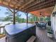 Outdoor deck features a jacuzzi and outdoor dining set with lake views at 7560 Island Mill Rd, Acworth, GA 30102