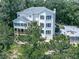 Stunning three-story home with a spacious deck, ample windows, and a charming outdoor entertainment area with fire pit at 7560 Island Mill Rd, Acworth, GA 30102