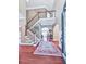 Grand foyer with hardwood floors, staircase, rug, and an open view of the home's interior at 7560 Island Mill Rd, Acworth, GA 30102