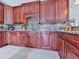 Elegant kitchen features custom wood cabinetry, granite countertops, and stylish backsplash at 7560 Island Mill Rd, Acworth, GA 30102