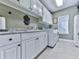Functional laundry room featuring white cabinets, a utility sink, and modern appliances at 7560 Island Mill Rd, Acworth, GA 30102