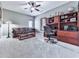 Comfortable home office with a ceiling fan, carpeted floors, and built-in wooden shelving at 7560 Island Mill Rd, Acworth, GA 30102