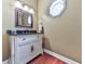 Stylish powder room with a decorative mirror and unique lighting fixture at 7560 Island Mill Rd, Acworth, GA 30102