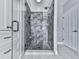 Luxurious tiled walk-in shower featuring a glass enclosure, rainfall shower head, and a built-in bench at 7560 Island Mill Rd, Acworth, GA 30102