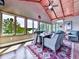 Bright sunroom with wood ceiling, fan, and large windows overlooking the lake at 7560 Island Mill Rd, Acworth, GA 30102
