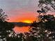 Scenic view of the sun setting over the lake, with trees in the foreground at 7560 Island Mill Rd, Acworth, GA 30102