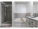 Well-lit bathroom featuring a separate shower, tub, and a modern vanity at 1982 Brightleaf Way, Marietta, GA 30060