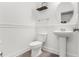 Clean powder room featuring a pedestal sink, modern lighting, and decorative mirror at 1982 Brightleaf Way, Marietta, GA 30060
