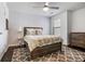 Inviting bedroom featuring a stylish bed, a ceiling fan and a patterned accent wall at 1982 Brightleaf Way, Marietta, GA 30060