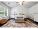 Bright bedroom with a ceiling fan, accent rug, and modern decor creating a cozy space at 1982 Brightleaf Way, Marietta, GA 30060