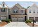 Charming brick townhome with a two-car garage and meticulously manicured landscaping at 1982 Brightleaf Way, Marietta, GA 30060