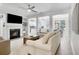 Open-concept living room with a fireplace, built-ins, and seamless flow to kitchen and dining area at 1982 Brightleaf Way, Marietta, GA 30060