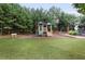 Community playground surrounded by mature trees and green space at 1982 Brightleaf Way, Marietta, GA 30060