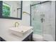 Modern bathroom featuring a white vanity, modern fixtures, and a walk-in shower at 2005 Simmons Ave, Atlanta, GA 30337