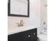 Modern bathroom featuring a black vanity, quartz countertop, and white marble tiled shower at 2005 Simmons Ave, Atlanta, GA 30337