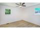 This bedroom has modern vinyl plank flooring, two windows, and is brightly lit at 2005 Simmons Ave, Atlanta, GA 30337