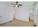 This bedroom has modern vinyl plank flooring, a ceiling fan and access to the bathroom at 2005 Simmons Ave, Atlanta, GA 30337