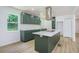 Modern kitchen boasts green cabinetry, stainless steel appliances, and a large island at 2005 Simmons Ave, Atlanta, GA 30337