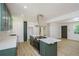 Updated kitchen featuring an island with seating, stainless appliances, and wood-look flooring at 2005 Simmons Ave, Atlanta, GA 30337