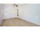 Bright living room featuring light wood floors, ceiling fan, and a white painted brick accent wall at 2005 Simmons Ave, Atlanta, GA 30337