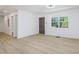 Bright, renovated living room with new wood-look flooring and freshly painted walls at 2005 Simmons Ave, Atlanta, GA 30337