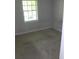 An empty bedroom with neutral walls and floors, and a large window at 2842 Jordan Forest Trail Northwest, Lawrenceville, GA 30044